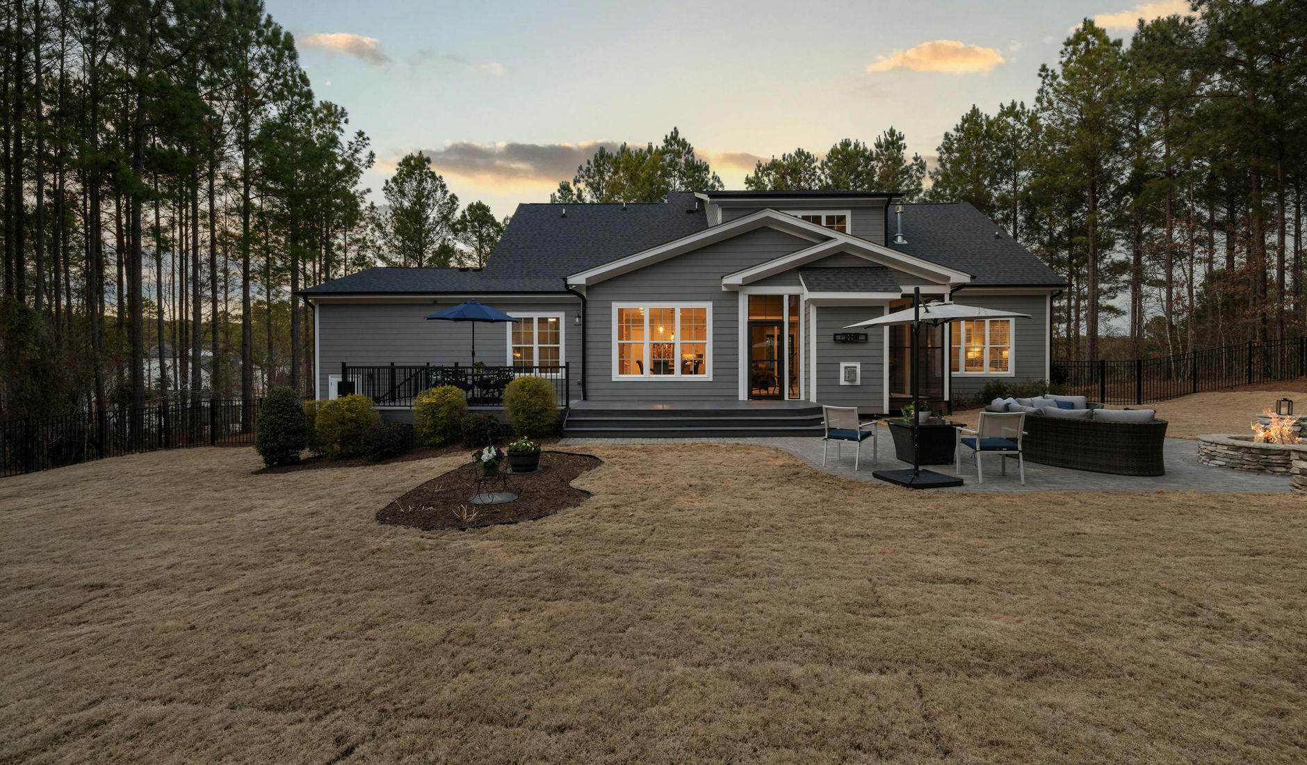Modern single-family home illuminated at sunset with a spacious backyard — the kind of project PML borrowers build, refinance, and rent