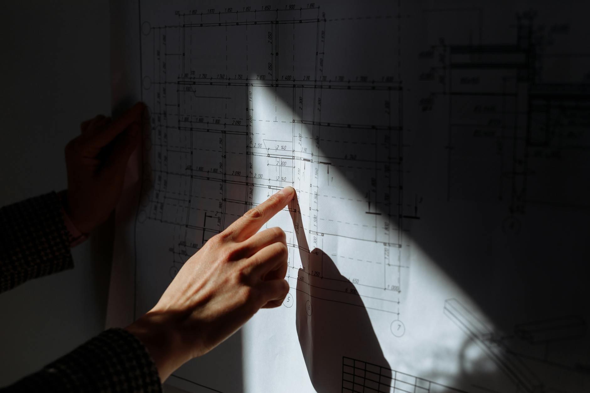 Construction blueprints under dramatic lighting