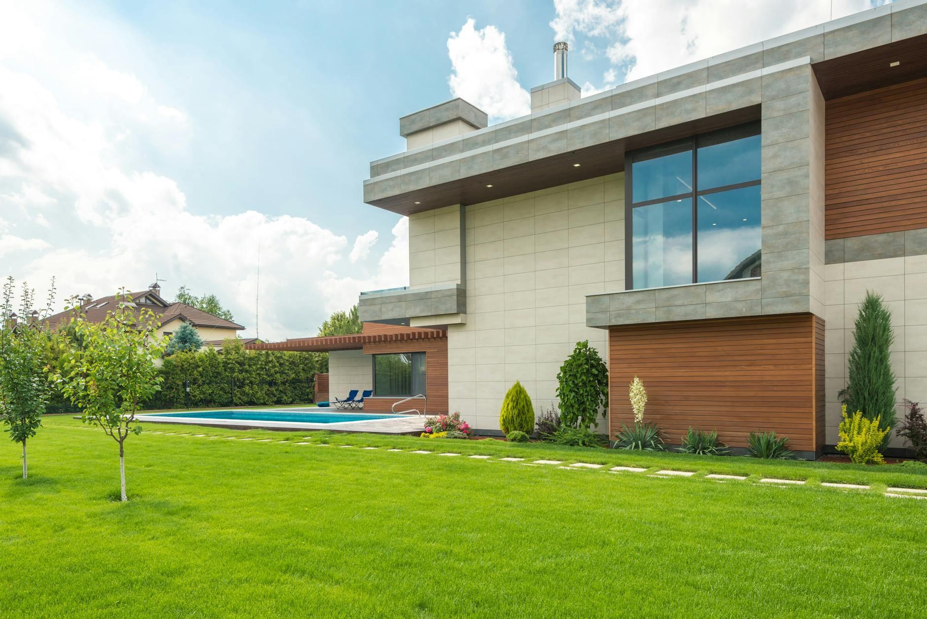 Modern single-family rental home with swimming pool and lush lawn